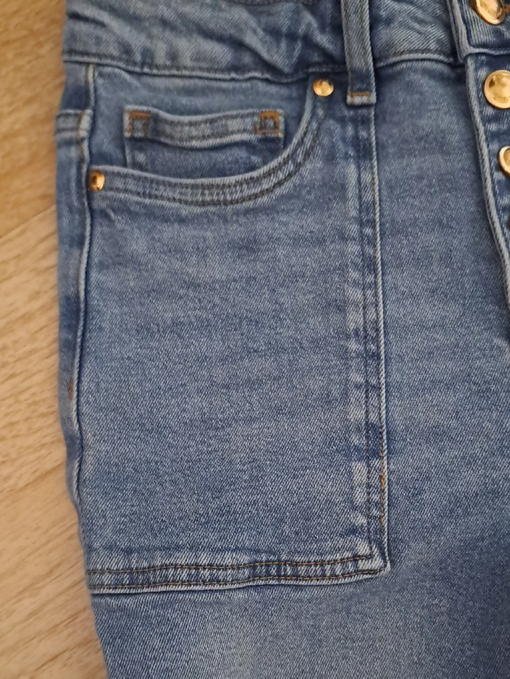 Michael Kors High Rise Light Blue Jeans with Gold Accents